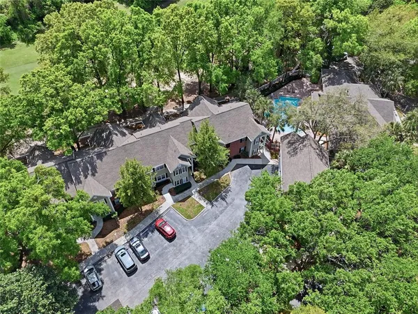 an aerial view of a house with a yard