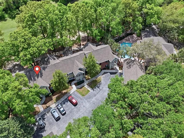 an aerial view of a house with a yard