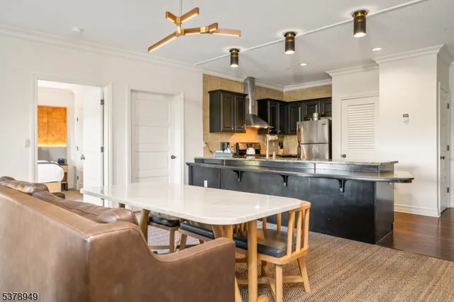 a kitchen with a table chairs sink and cabinets