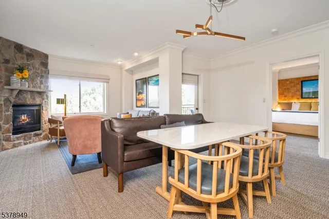 a view of a dining room with furniture and a fireplace
