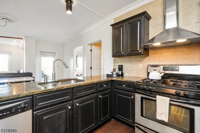 a kitchen with stainless steel appliances a stove sink and cabinets