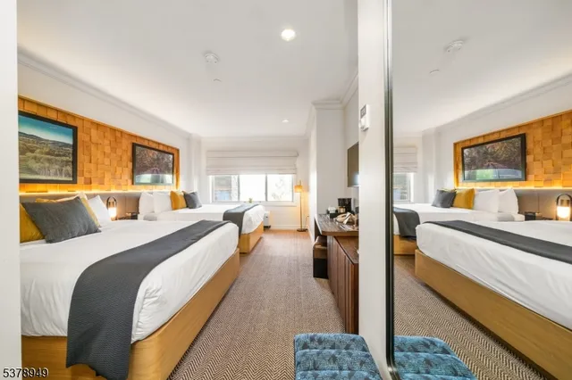 a bed room with a bed and a large window