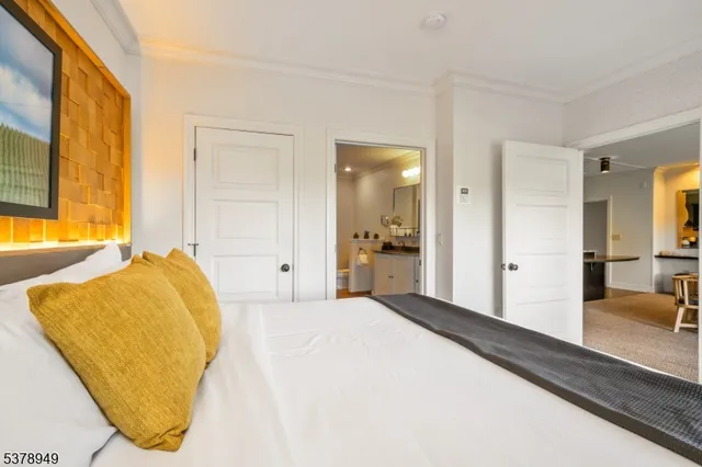 a spacious bedroom with a bed and wooden floor