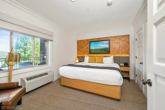 a bedroom with a large bed and a large window