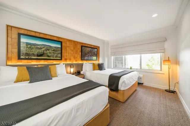 a bedroom with a large bed and a window