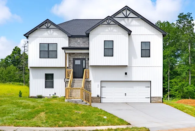 a front view of a house with a yard and garage