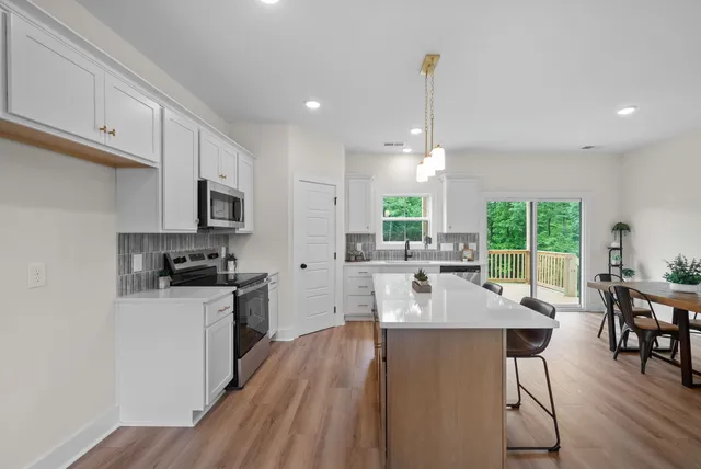 a kitchen with a sink a stove a refrigerator and cabinets