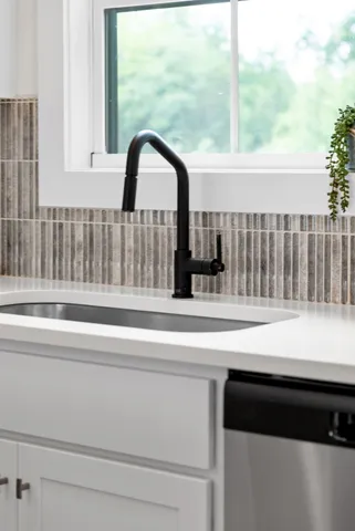 a kitchen with stainless steel appliances kitchen island granite countertop a stove a sink and a refrigerator