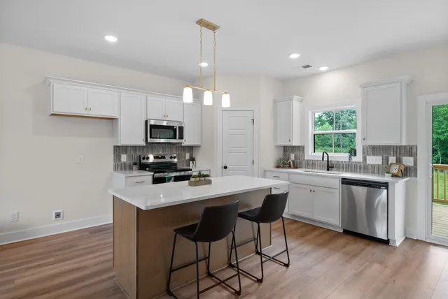 an empty room with a window and a ceiling fan