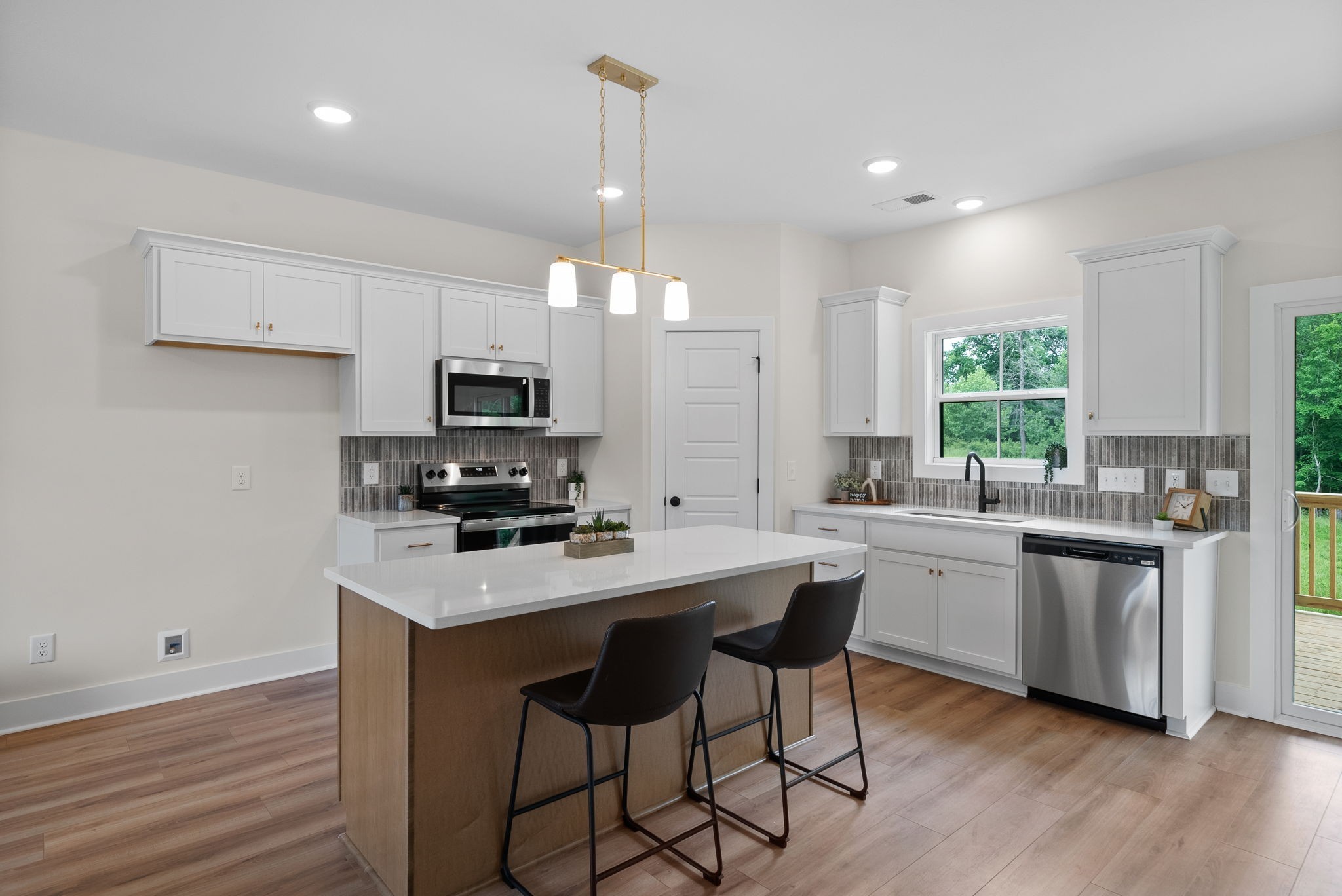 197 Dewberry Road Clarksville, TN 37042 - Photo 27 of 59 a kitchen with stainless steel appliances granite countertop a stove top oven a sink dishwasher a refrigerator and white cabinets with wooden floor
