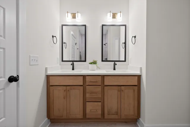 a bathroom with a sink a mirror and window