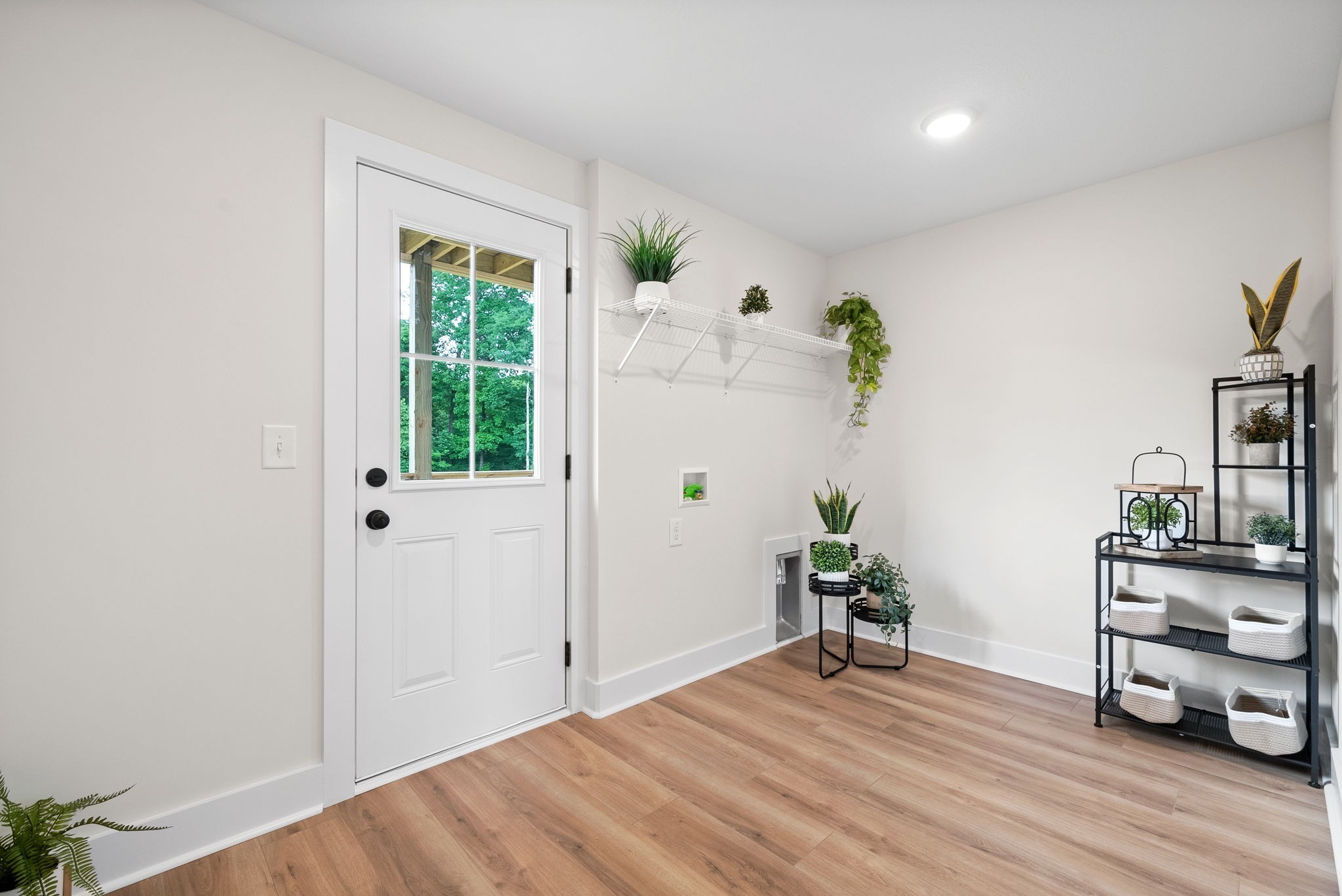 197 Dewberry Road Clarksville, TN 37042 - Photo 47 of 59 a view of a livingroom with wooden floor and a potted plant