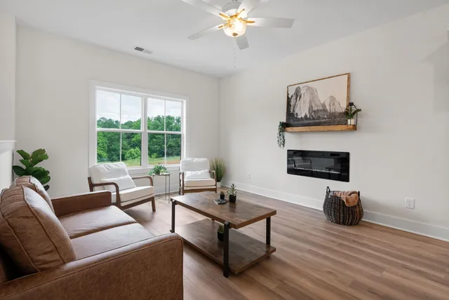 a view of living room with furniture and wall painting