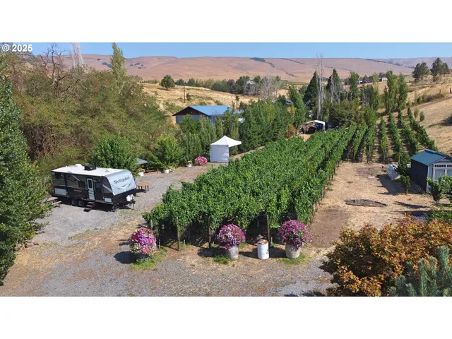 a backyard of a house with a yard and outdoor seating