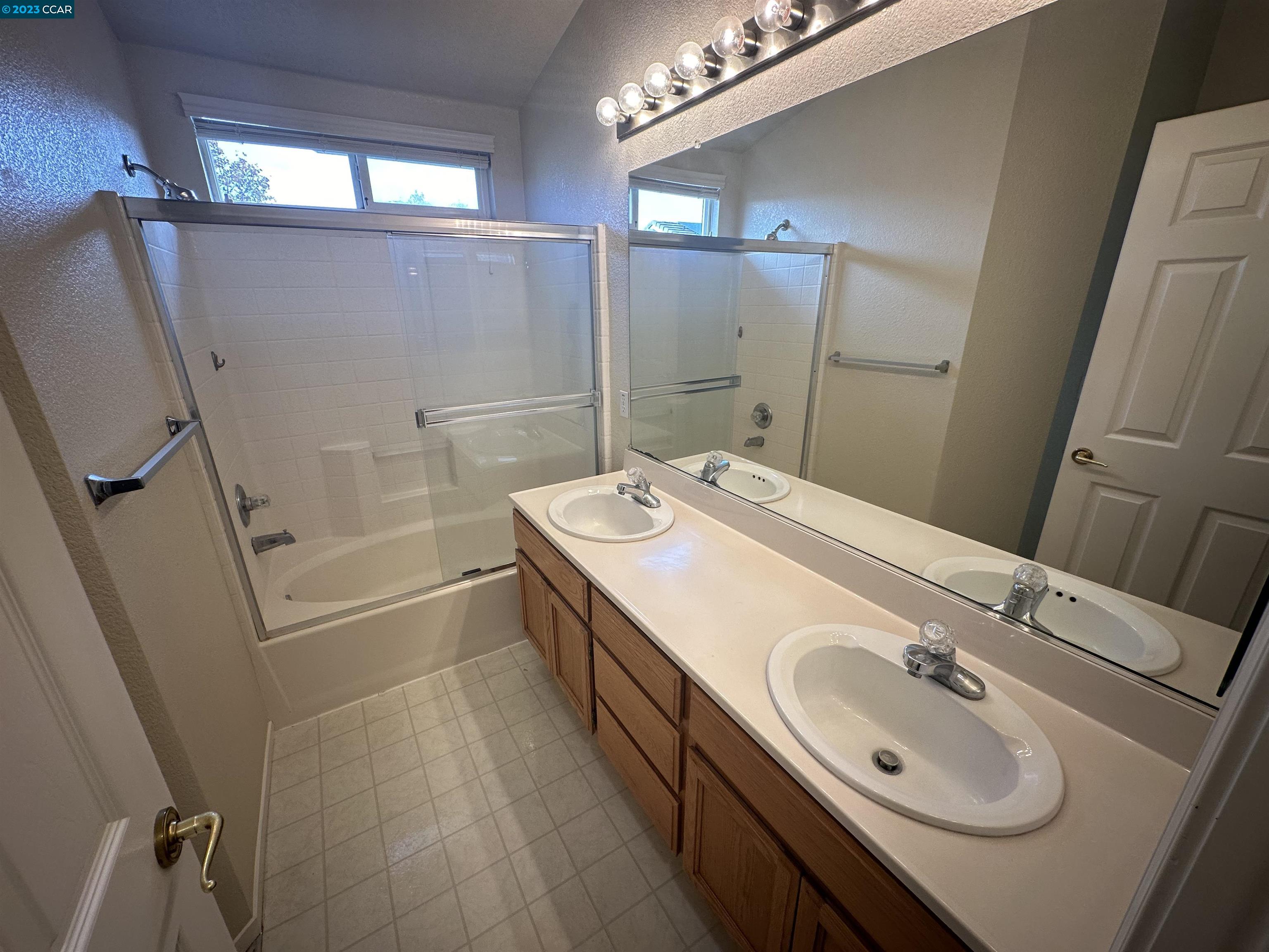 4653 Myrtle Drive Dublin, CA 94568 - Photo 18 of 25 a bathroom with a sink a toilet a mirror and shower