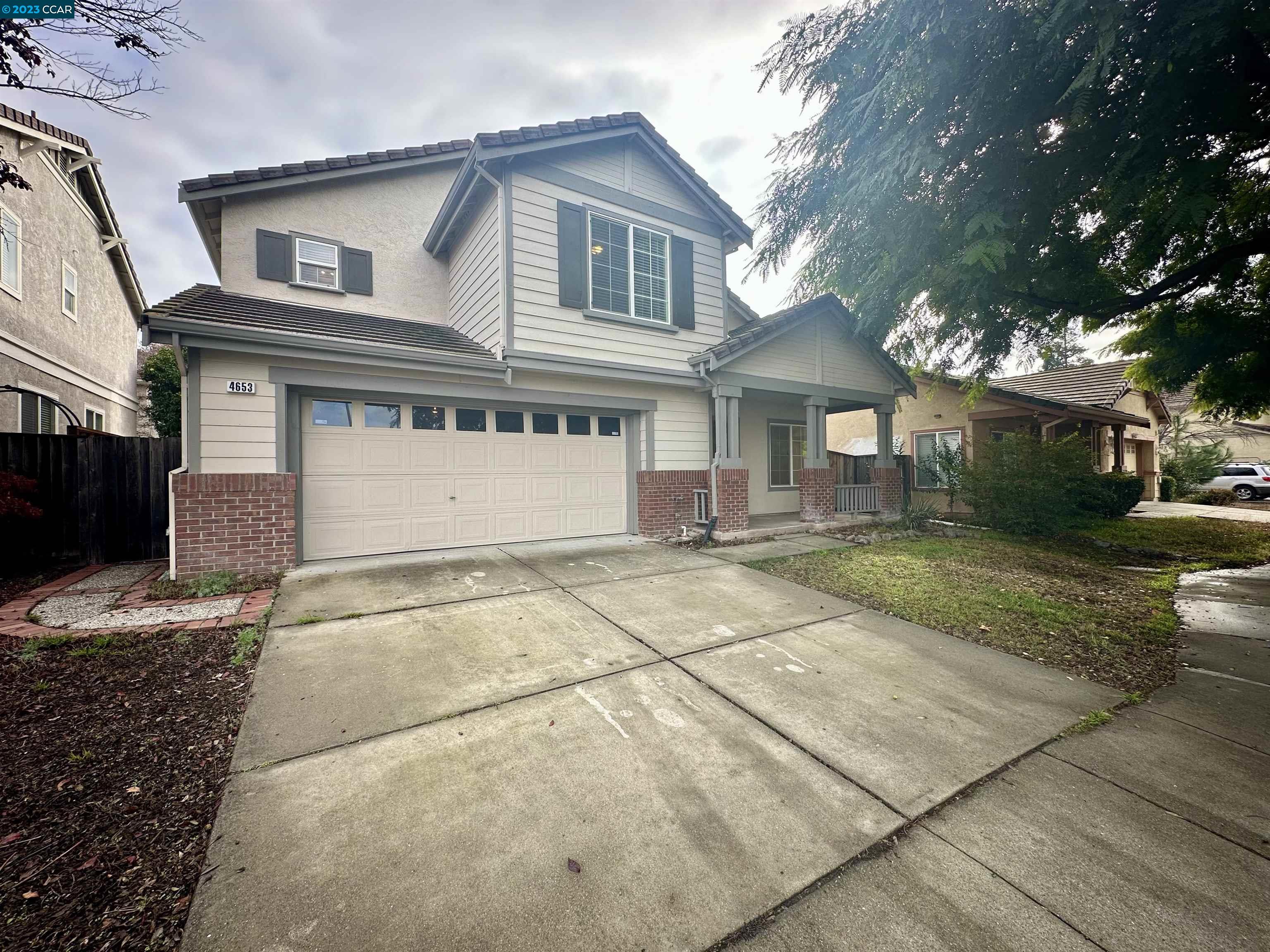 4653 Myrtle Drive Dublin, CA 94568 - Photo 2 of 25 a front view of a house with a yard and garage