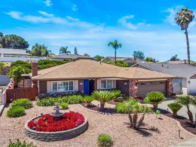 a view of a patio with table and chairs under an umbrella