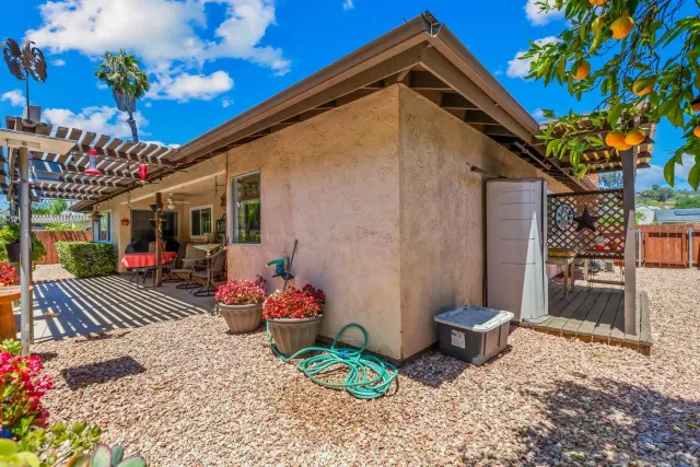 a view of a chairs and table in a backyard