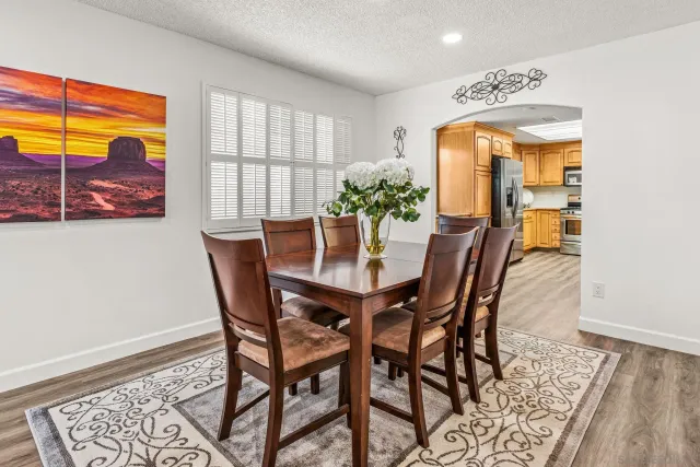 a dining room with furniture and wooden floor