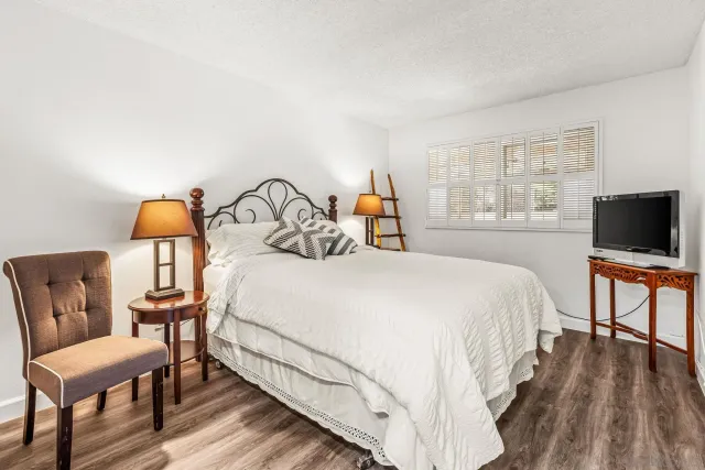 a bedroom with a bed and a television