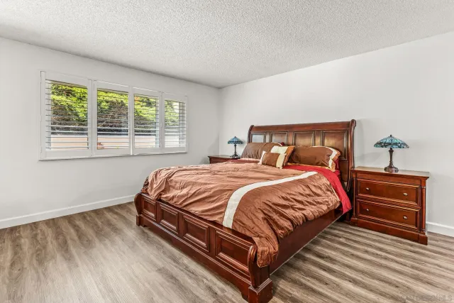 a bed sitting in a bedroom next to a window