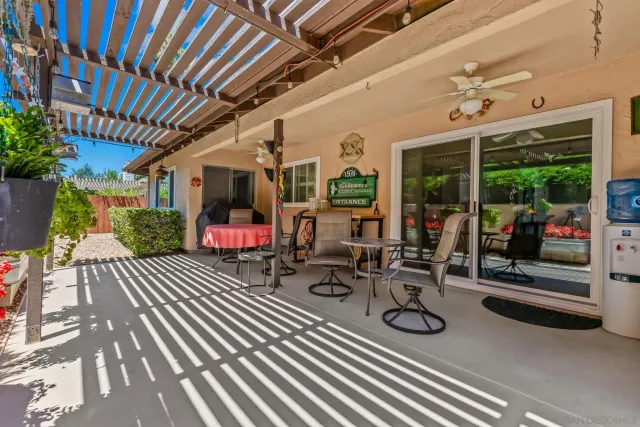 a view of a patio with table and chairs potted plants with wooden floor