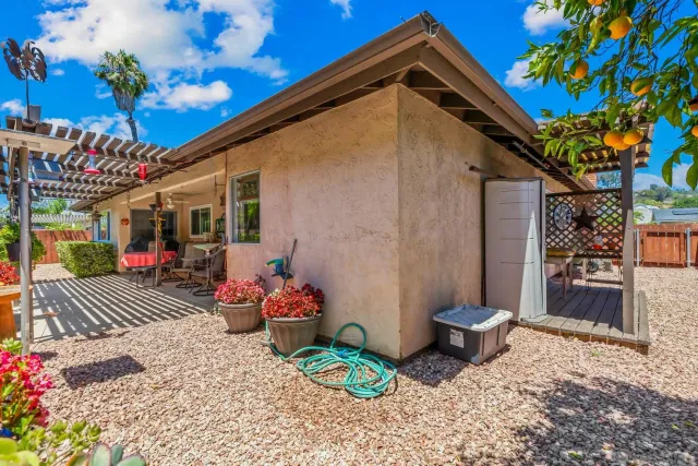 a view of a chairs and table in a backyard