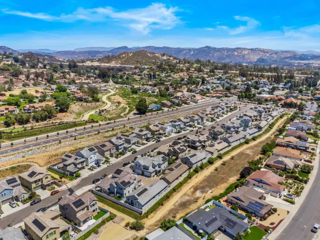 an aerial view of residential houses with city view