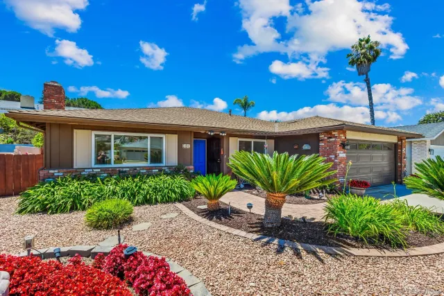 a front view of a house with a garden