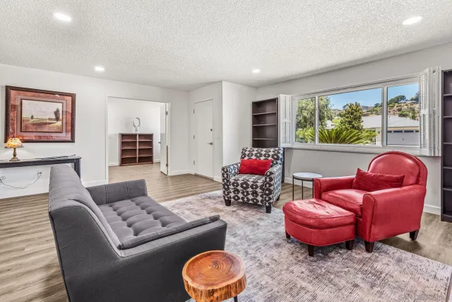 a living room with furniture and a large window