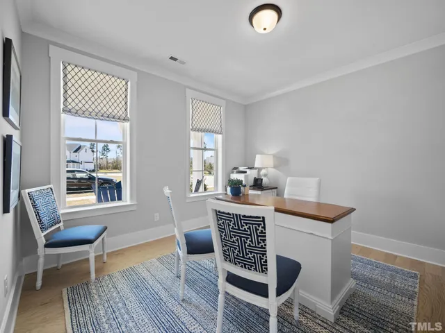 a view of a dining room with furniture and chandelier