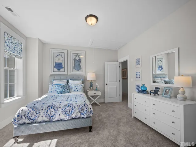 a bathroom with a double vanity sink a toilet a mirror and shower