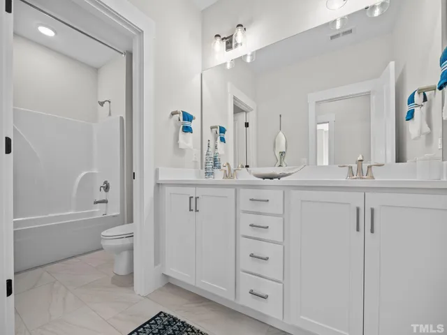 a bathroom with a double vanity sink and mirror
