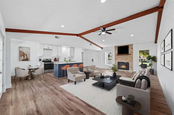 a living room with fireplace furniture and a wooden floor