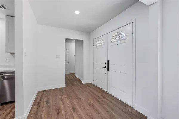 a view of a hallway with wooden floor