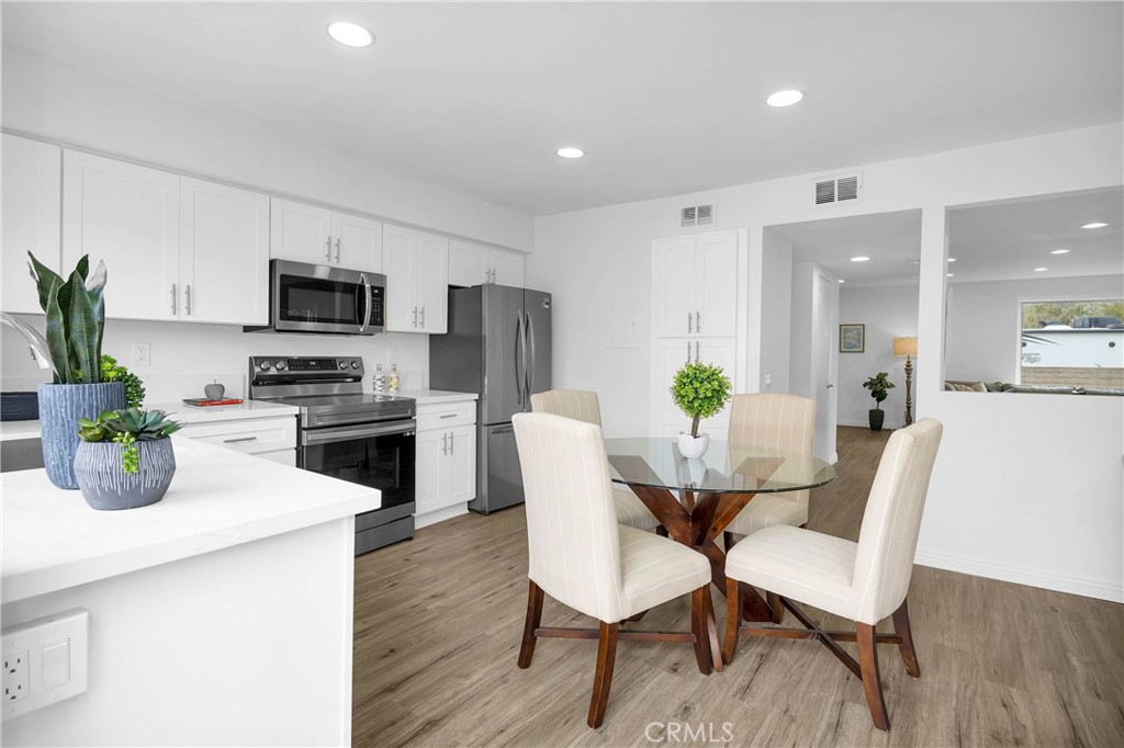 4345 Larwin Avenue Cypress, CA 90630 - Photo 11 of 54 a kitchen with a dining table chairs and refrigerator