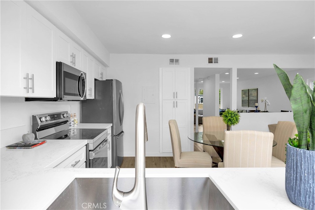 4345 Larwin Avenue Cypress, CA 90630 - Photo 13 of 54 a living room with stainless steel appliances kitchen island granite countertop furniture and a kitchen view