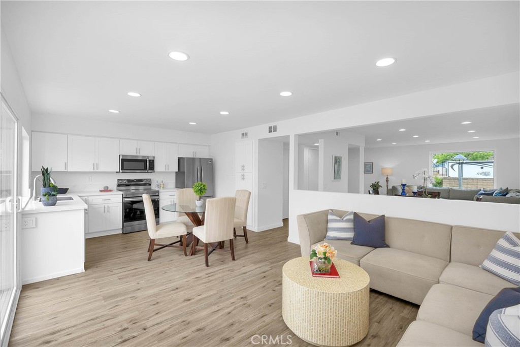 4345 Larwin Avenue Cypress, CA 90630 - Photo 17 of 54 a living room with stainless steel appliances furniture and a wooden floor