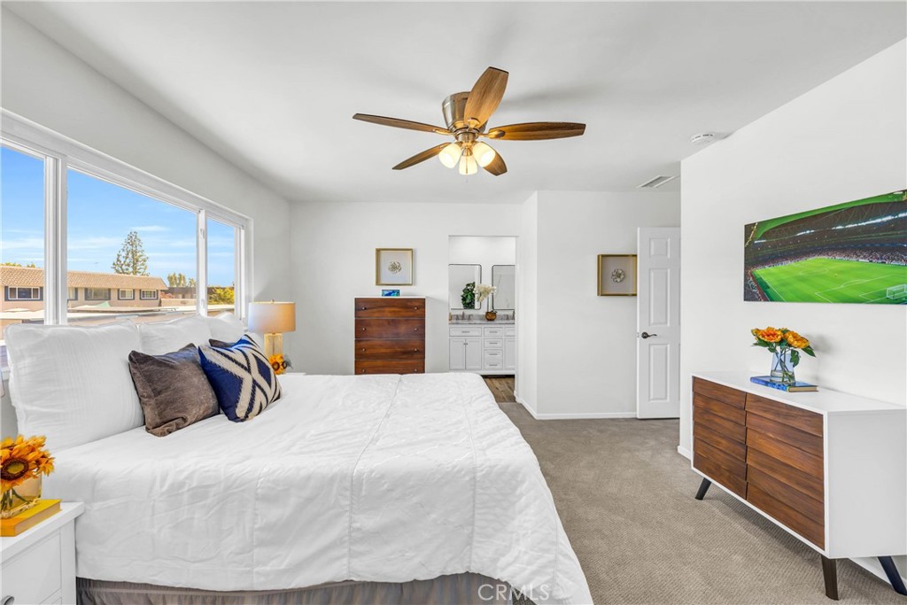 4345 Larwin Avenue Cypress, CA 90630 - Photo 19 of 54 a bedroom with a bed and a chandelier