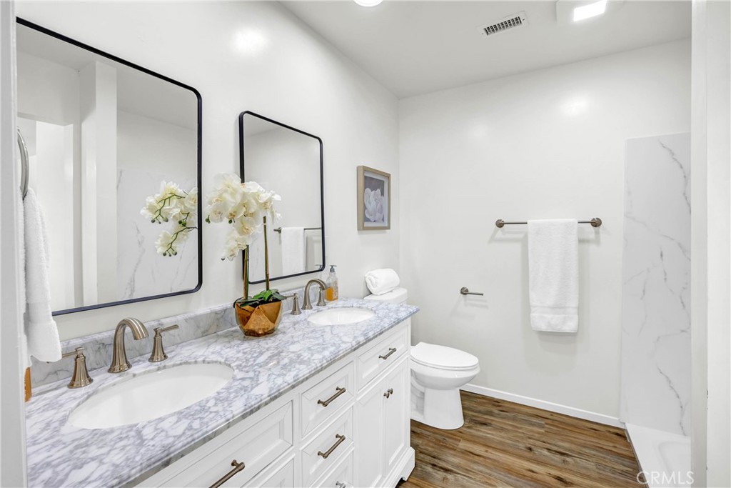 4345 Larwin Avenue Cypress, CA 90630 - Photo 24 of 54 a bathroom with a granite countertop sink toilet and shower