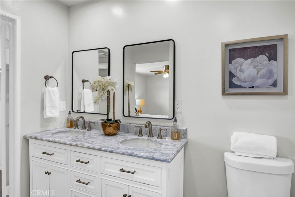 4345 Larwin Avenue Cypress, CA 90630 - Photo 26 of 54 a bathroom with a granite countertop sink and a mirror