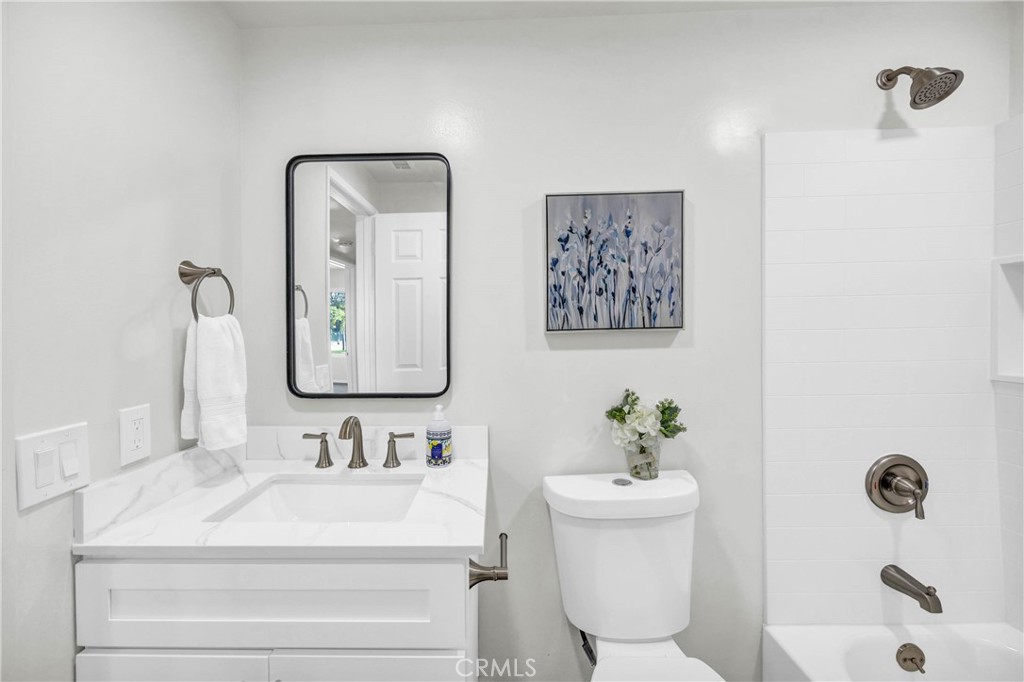 4345 Larwin Avenue Cypress, CA 90630 - Photo 30 of 54 a bathroom with a sink mirror and toilet