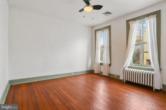 an empty room with wooden floor