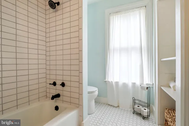 a bathroom with a sink mirror and vanity