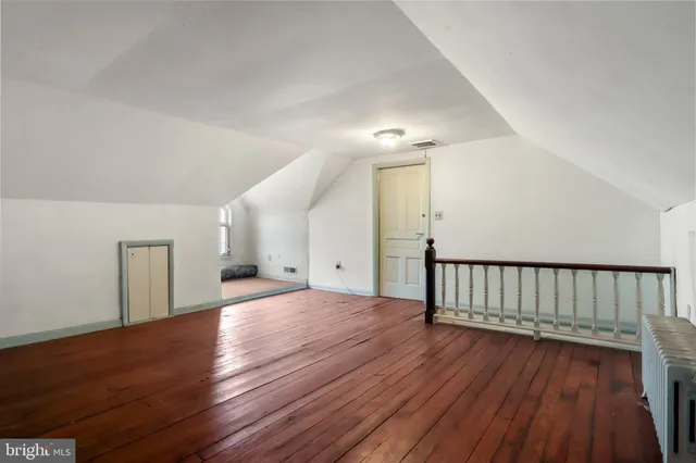 a view of entryway with furniture and wooden floor