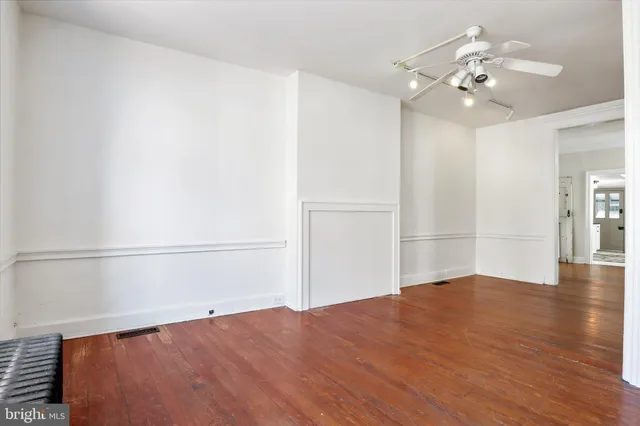 a view of an entryway with wooden floor and door