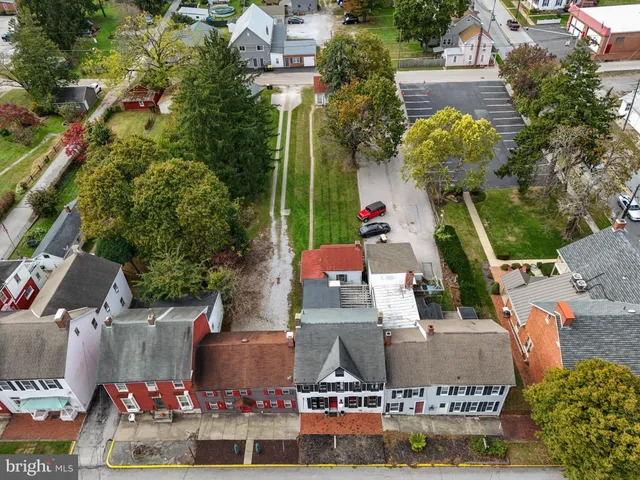 front view of house with a yard and potted plants