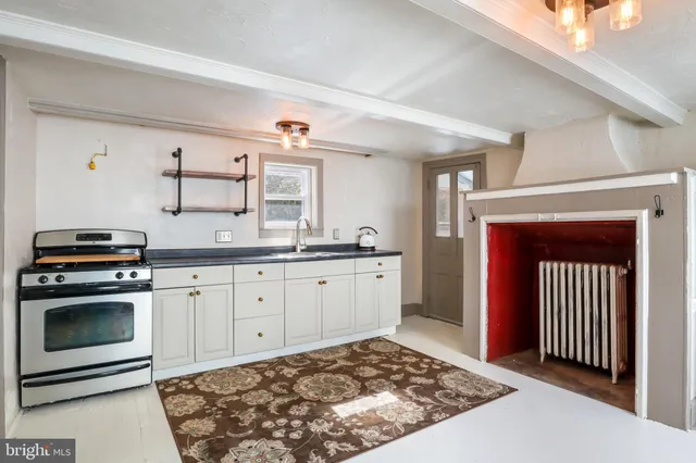 a kitchen with a stove a sink and a refrigerator