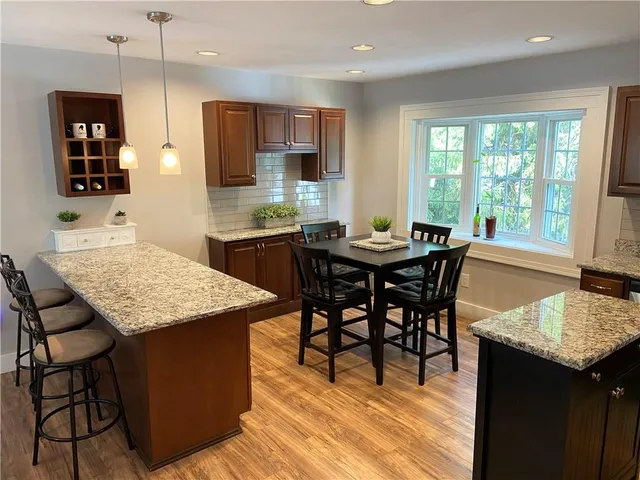 a room with painting on the wall and a wooden floor