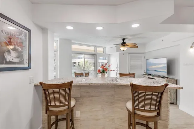 a living room with furniture ceiling fan and a rug